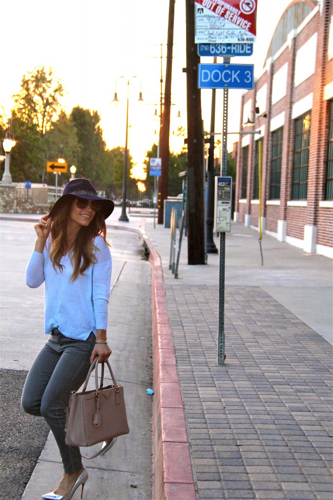 grey jeans, blue sweater, navy fedora 