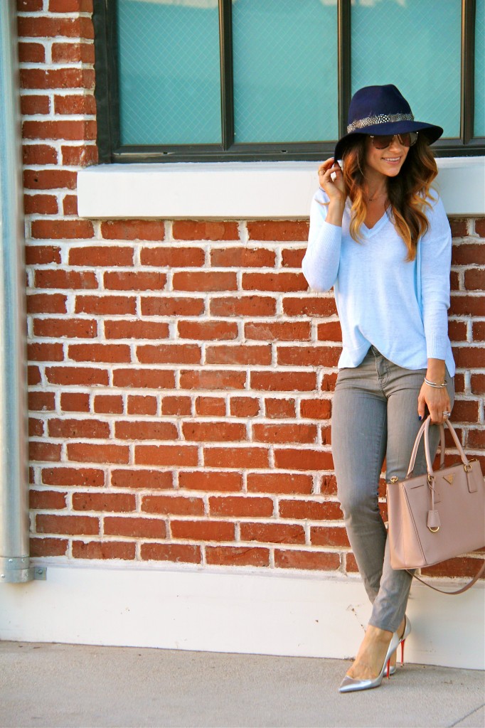 grey jeans, blue sweater, navy fedora 