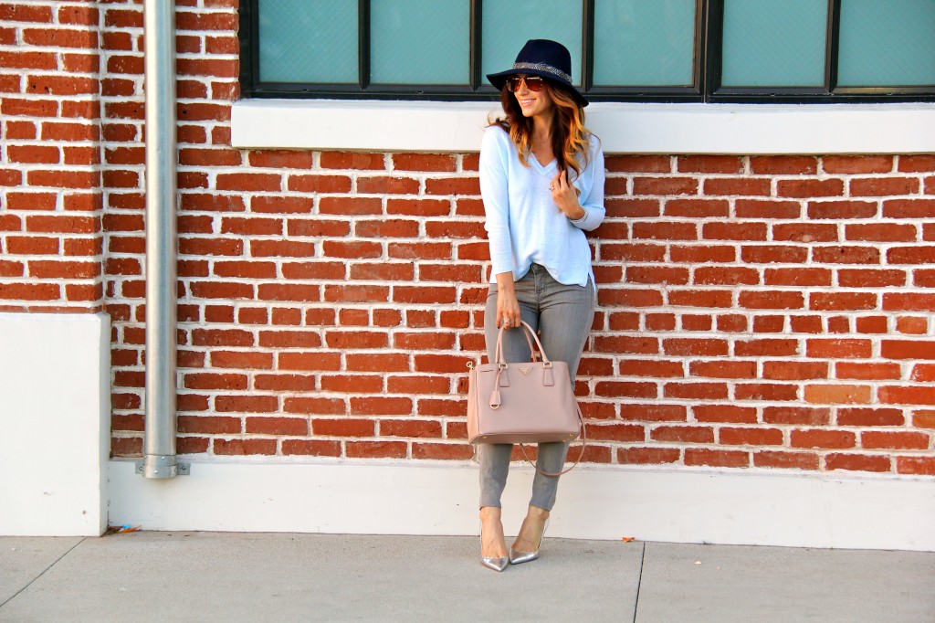 grey jeans, blue sweater, navy fedora 