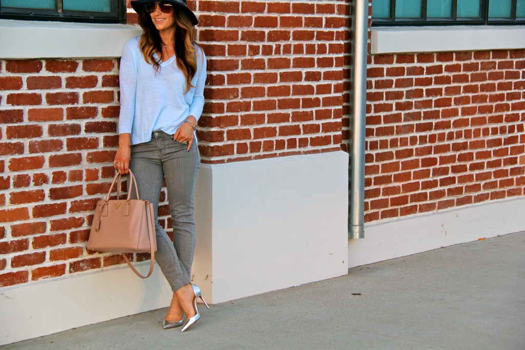 grey jeans, blue sweater, navy fedora