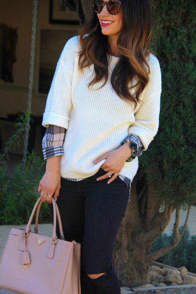 white sweater layered with plaid top