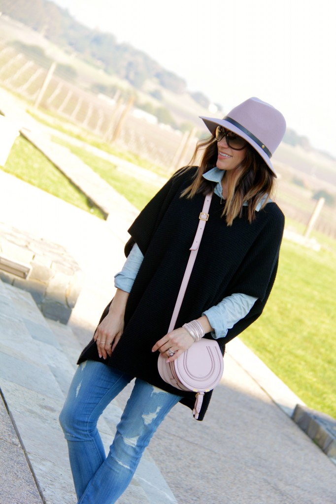 pink fedora, black poncho 